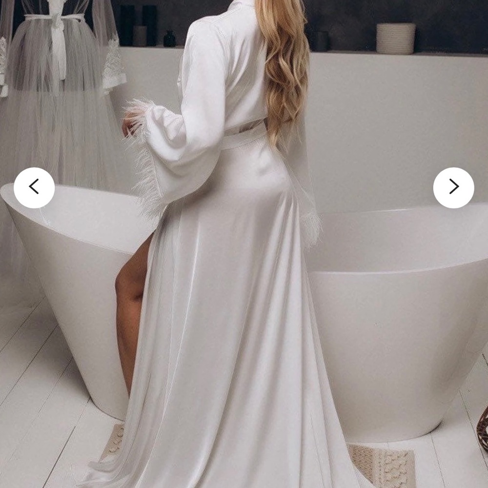Bridal robe with long train and feather trim sleeves